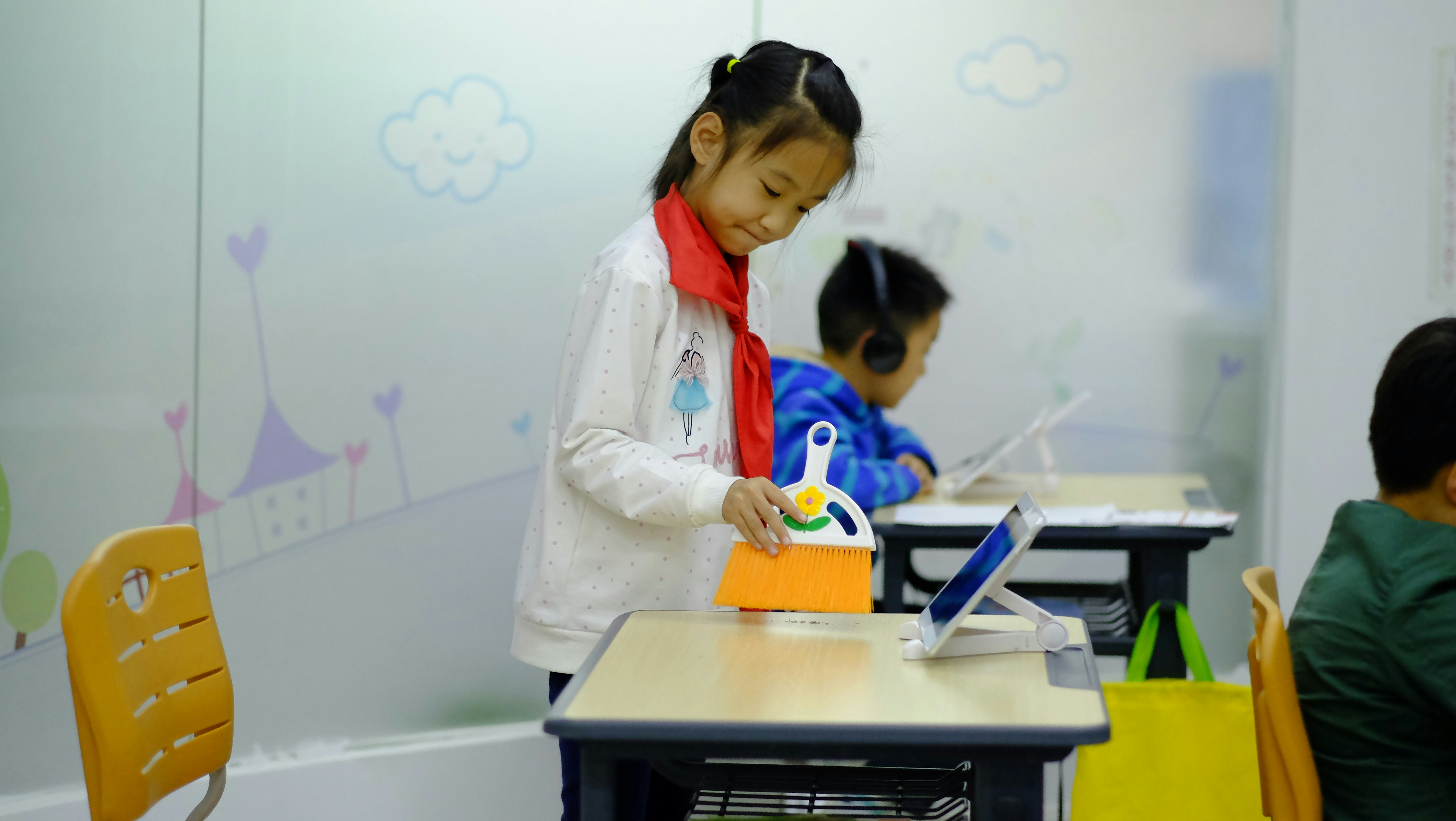 a group of children sitting at desks in a classroom